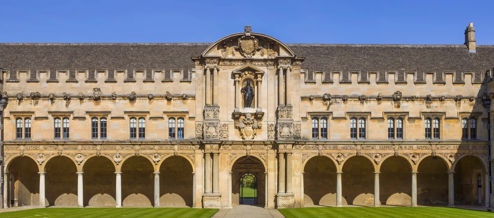Canterbury Quad at St John's College: a two-storey arcade of round stone arches running the length of the quad, in honey-coloured stone.