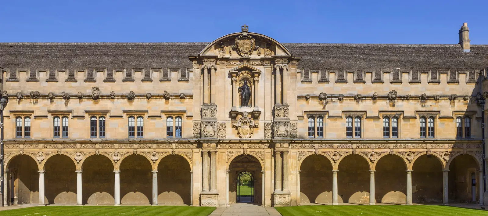 Canterbury Quad at St John's College: a two-storey arcade of round stone arches running the length of the quad, in honey-coloured stone.